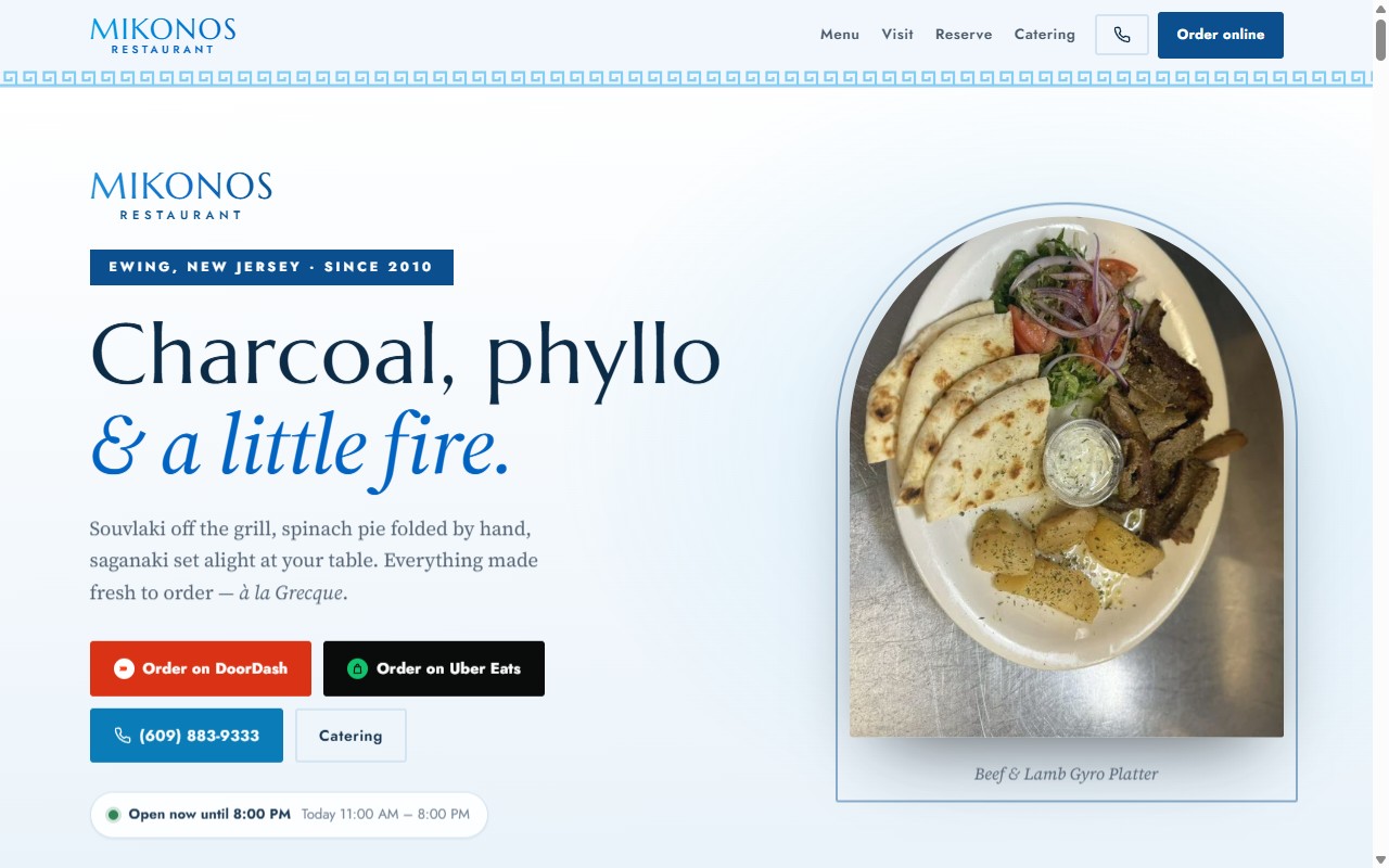 The Mikonos restaurant site: charcoal-grilled food photography, ordering buttons and live opening hours.